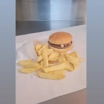 A T&D Ford burger and chips, plated and ready to wrap.