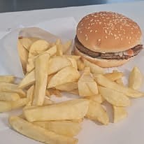 A T & D Ford burger in a sesame bun with a generous portion of chips.