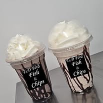 Two T & D Ford milkshakes topped with cream and chocolate sauce.